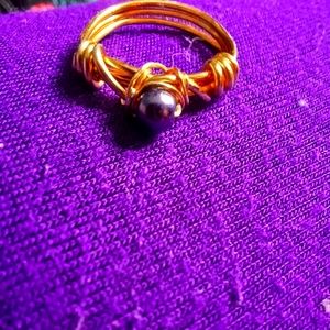 Copper-based wire-wrapped ring in gold-colored wire.